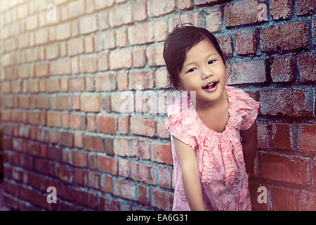 Portrait of girl leaning against wall Stock Photo