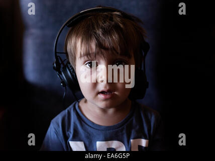 Boy wearing headphones and listening music Stock Photo