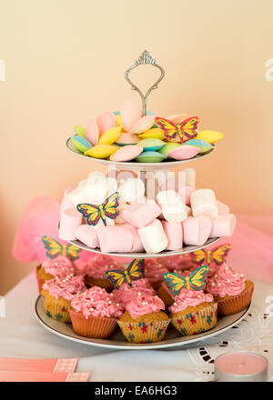 Cupcakes, flying saucers and marshmallows on a tiered cake stand Stock Photo