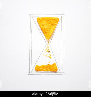 Conceptual sand running through a hourglass Stock Photo