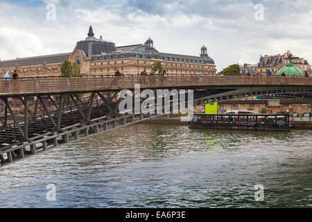 Paris, France - August 07, 2014: People walking on the footbridge Passerelle Leopold-Sedar-Senghor in rainy summer day Stock Photo
