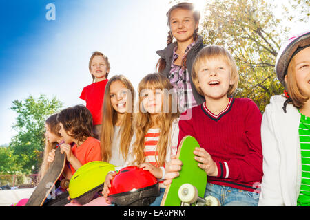 Positive children with skateboards and helmets Stock Photo