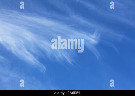 Cirrus and Cumulus clouds against a dark blue sky. Stock Photo
