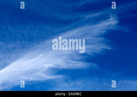 Cirrus and Cumulus clouds against a dark blue sky. Stock Photo