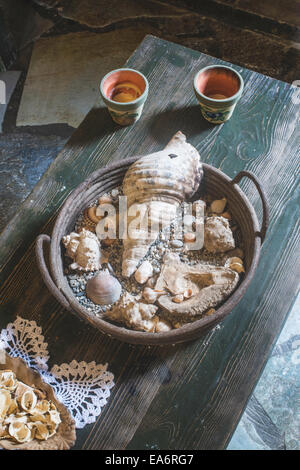 Marine souvenirs on table. Window light Stock Photo