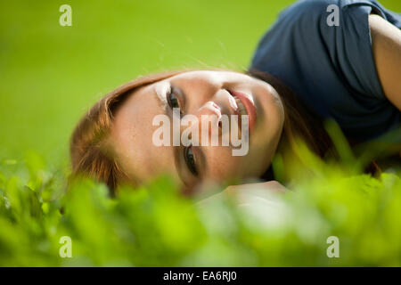 girl lying on the grass and smiling Stock Photo
