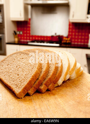 Wholemeal and white bloomer bread slices in a domestic kitchen Stock Photo