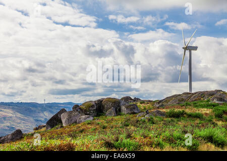 Wind turbine generator on top of a hill for the production of clean and renewable energy in Terras Altas de Fafe, Portugal Stock Photo