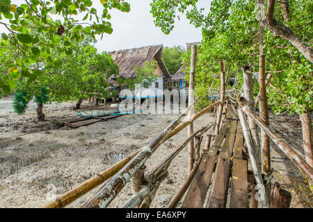 Tubigon Town, Bohol Island, Philippines - Bamboo catwalk leads to the Tinangnan Beach Resort. Low tide. Stock Photo