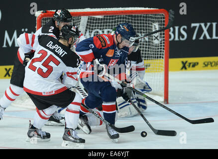 Munich, Germany. 07th Nov, 2014. Canada's Micki Dupont (L) and Slovakia's Lukas Cingel during the Deutschland Cup match between Canada and Slovakia in the Olympic Eissporthalle in Munich, Germany, 07 November 2014. Photo: ANDREAS GEBERT/dpa/Alamy Live News Stock Photo