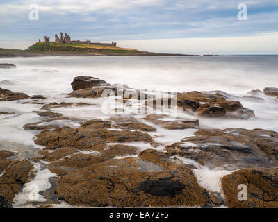 The stunningly rugged coastline of Holy Island in Northumberland is protected by Lindisfarne Castle on a beautiful winters morni Stock Photo