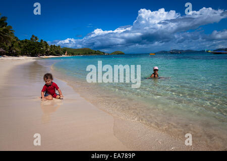 Tropical Vacation - Mother and son relaxing in the clear beautiful Ocean Stock Photo