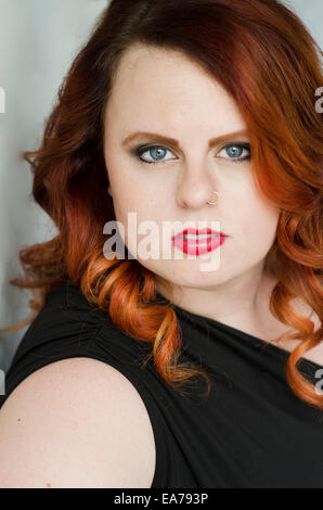 Studio portrait of gingerhead young adult woman Stock Photo