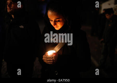Berlin, Germany. 7th Nov, 2014. A woman holding a candle takes part in a memorial activity for the Crystal Night at Berlin's Grunewald train station in Berlin, Germany, on Nov. 7, 2014. Some 100 middle school students and students from the local police school took part in the memorial activity on Friday to commemorate the 76th anniversary of the Nazi's 'Kristallnacht' (Crystal Night, Night of Broken Glass) in 1938, at Berlin's Grunewald train station, one of the major sites of deportation of the Berlin Jews during World War II. Credit:  Zhang Fan/Xinhua/Alamy Live News Stock Photo