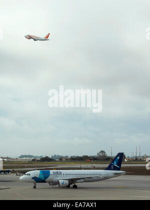 easyJet airplane taking off while a SATA aircraft waits for its turn on the runway Stock Photo