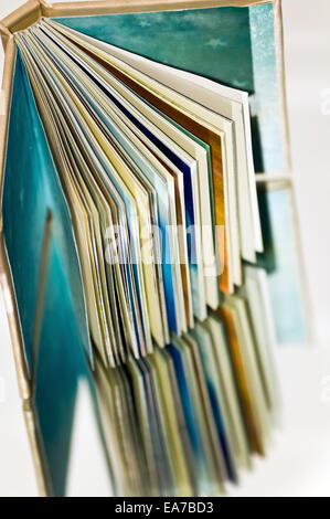 Looking down on an open book sitting on a reflective surface Stock Photo
