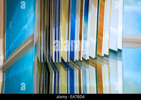 close up of an open book on top of a reflective surface Stock Photo
