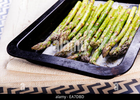Fresh asparagus spears with salt, pepper and oil ready to be grilled or roasted Stock Photo