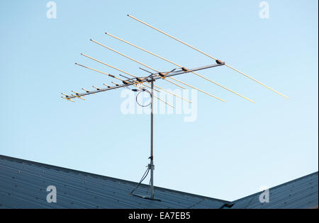 Digital TV aerial or antenna on top of a house Stock Photo