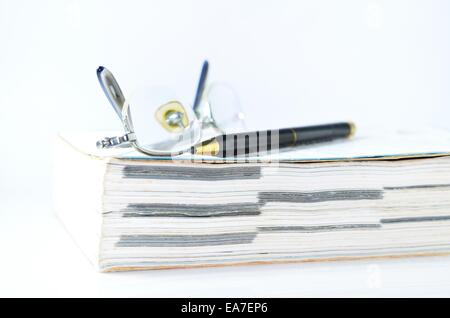 Glasses with pen and book Stock Photo