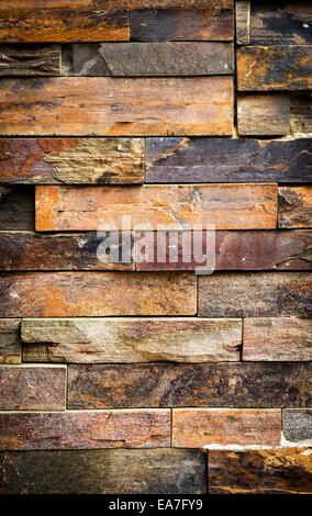 Stacked stone cladding building facade for background texture Stock Photo