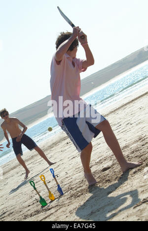 Playing cricket on the beach North Cornwall South West England UK Stock Photo