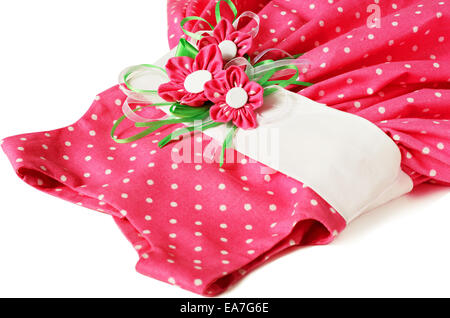 Pink polka-dot dress with artificial textile flowers isolated on white Stock Photo