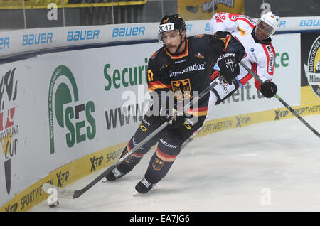 Munich, Germany. 07th Nov, 2014. Germany's goalkeeper Patrick Reimer (FRONT) and Switzerland's Clarence Kparghai in action during the German Cup match for ice hockey between Germany and Switzerland at the Olympia Ice Rink in Munich, Germany, 07 November 2014. Photo: ANDREAS GEBERT/dpa/Alamy Live News Stock Photo