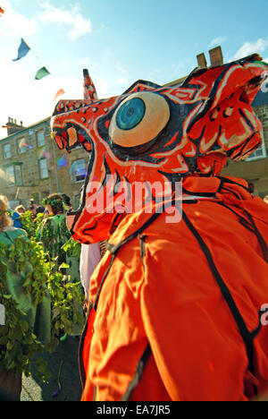 Closeup of red dragon in a performance of The Hal An Tow at the bottom of Coinagehall Street by the monument on Flora Day in Hel Stock Photo