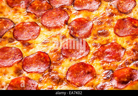 Appetizing background pepperoni pizza closeup filling the frame. Stock Photo