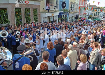 The Childrens Dance going up Coinagehall Street to the Guildhall on Flora Day in Helston Kerrier West Cornwall South West Englan Stock Photo