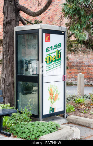 BT public phone booth with advertising on the glass for McDonalds products. Maidenhead, Berkshire, England, GB, UK. Stock Photo
