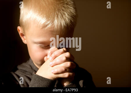 Little young beautiful boy (child, kid) spiritual peaceful praying and wishing, horizontal, copy space. Stock Photo