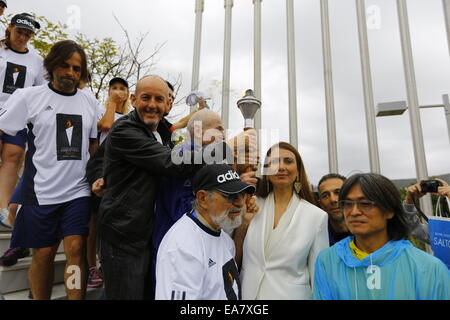 Athens, Greece. 8th November 2014. Attendees of the opening ceremony of the 32nd Athens Marathon pose with the Marathon Flame Torch. The Marathon Flame of the 32nd Athens Marathon has been lit in the start venue of the Marathon in Marathon. The flame will burn for the whole marathon weekend. A record number of 13,000 Marathon runners is registered for this year's race. Credit:  Michael Debets/Alamy Live News Stock Photo