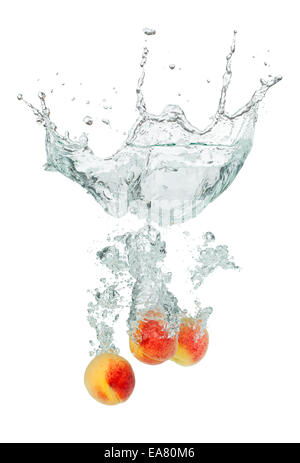 Isolated shot of apricots falling into water, isolated on white background Stock Photo