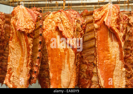 Lots of hanging smoked pork ribs on stock Stock Photo