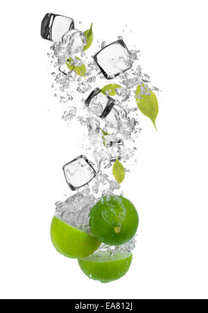 Falling pieces of limes in water splash and ice cubes, isolated on white background Stock Photo