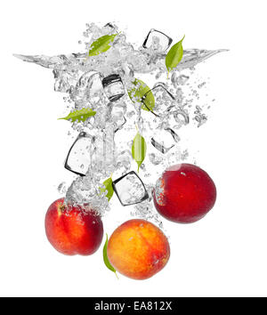 Falling pieces of nectarines in water splash and ice cubes, isolated on white background Stock Photo