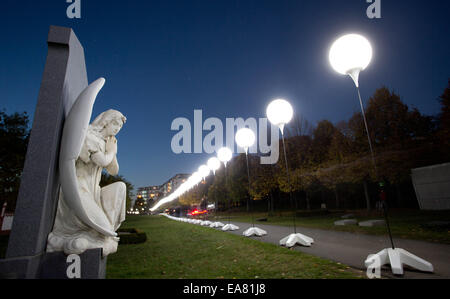 Berlin, Germany. 08th Nov, 2014. Balloon lanterns in the Invaliden cemetery in Berlin, Germany, 08 November 2014. The lanterns are part of the 'Border of Lights 2014' project to commemorate the 25th anniversary of the Fall of the Berlin Wall on 09 November 2014. Photo: JOERG CARSTENSEN/dpa/Alamy Live News Stock Photo