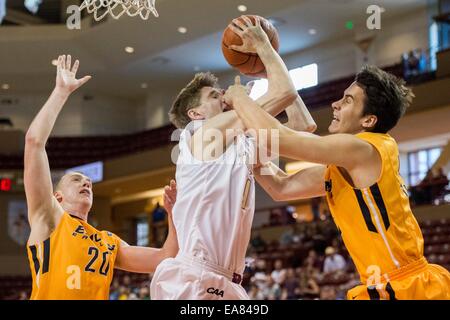 Charleston, SC, USA. 8th Nov, 2014. College of Charleston G John Eck (4) is fouled by Emory F/C Christopher Avant (45) during the NCAA Basketball game between Emory University and the College of Charleston at TD Arena on November 8, 2014 in Charleston, South Carolina.College of Charleston defeats Emory 78-68. Credit:  Cal Sport Media/Alamy Live News Stock Photo