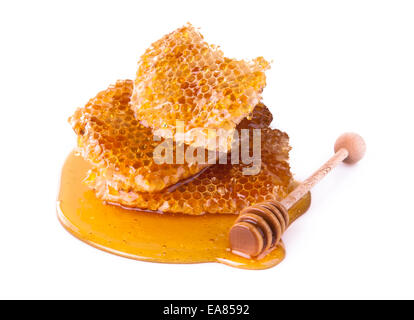 Studio shot of honeycomb and drizzler, isolated on white background Stock Photo