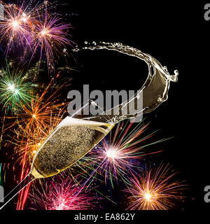 Champagne glass with fireworks on background Stock Photo