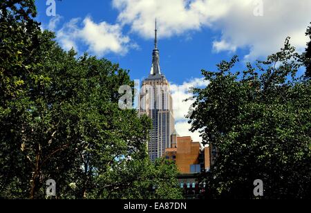 NYC:   View from Madison Square park to the 102 story Empire State Building wit its needle TV aerial is an art deco masterpiece