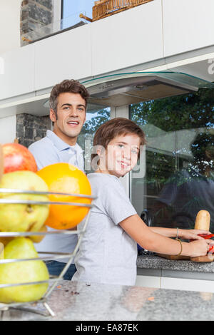 Portrait of happy father and son cooking in kitchen Stock Photo - Alamy