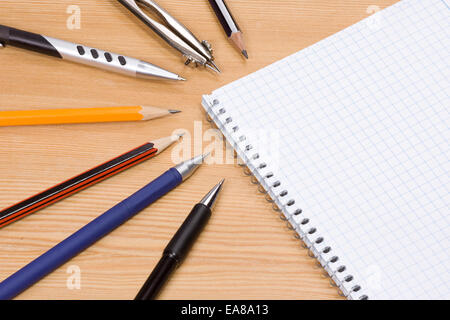 compasses, pens and pad on table Stock Photo