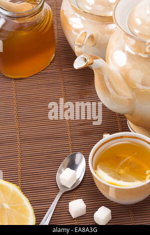 tea, pot and honey on table Stock Photo