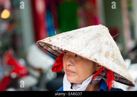 Portrait of Vietnamese woman in traditional conical hat Stock Photo