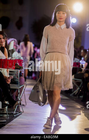 Calgary, Alberta, Canada. 8th Nov, 2014. A model displays her paris influenced outfit featuring a a Brunello Cucinelli sweater, with a collared Dries Van Noten shirt with a skirt from Needle and Thread. To accent the look a Michael Kors hand bag and bracelets from the Kate Spade collection. Credit:  Baden Roth/ZUMA Wire/Alamy Live News Stock Photo