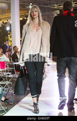 Calgary, Alberta, Canada. 8th Nov, 2014. A model displays her paris influenced look which features a top blouse from Cami, an H BRAND Jacket and rolled up jeans from Pink Tartan. The hand bag is a debut in Calgary and is a Givenchy brand. Credit:  Baden Roth/ZUMA Wire/Alamy Live News Stock Photo