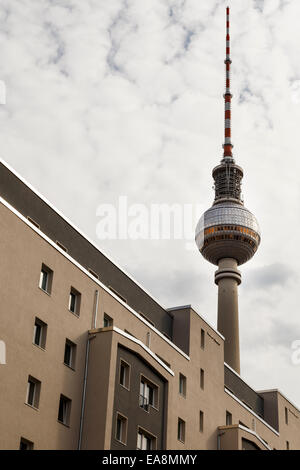Fernsehturm TV Tower seen over roof of building on Rosa-Luxemburg-Strasse, Mitte, Berlin, Germany Stock Photo
